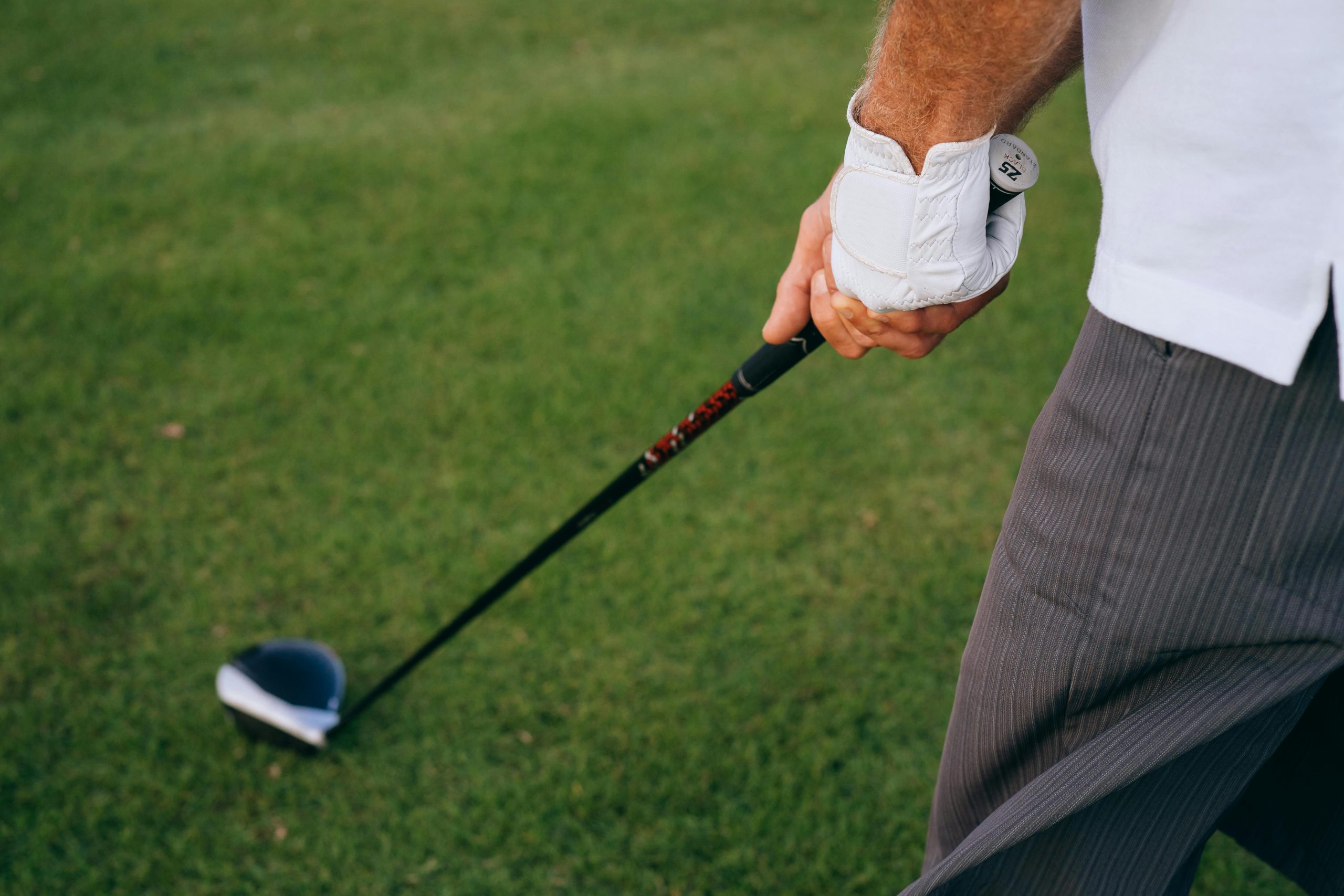 Golfer holding a strong grip on a driver during setup on the tee
